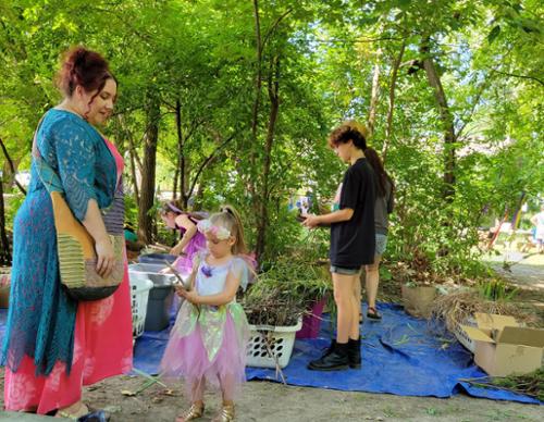 patrons gather building materials for their fairy house constructs'