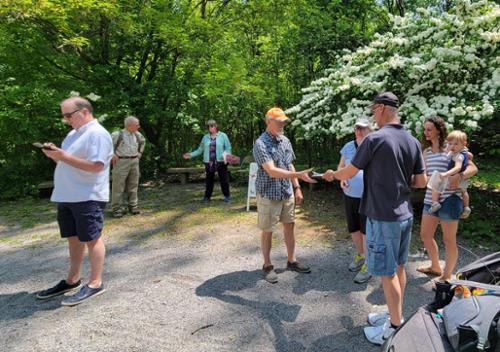 people gather for a tour of the park's nature and history.